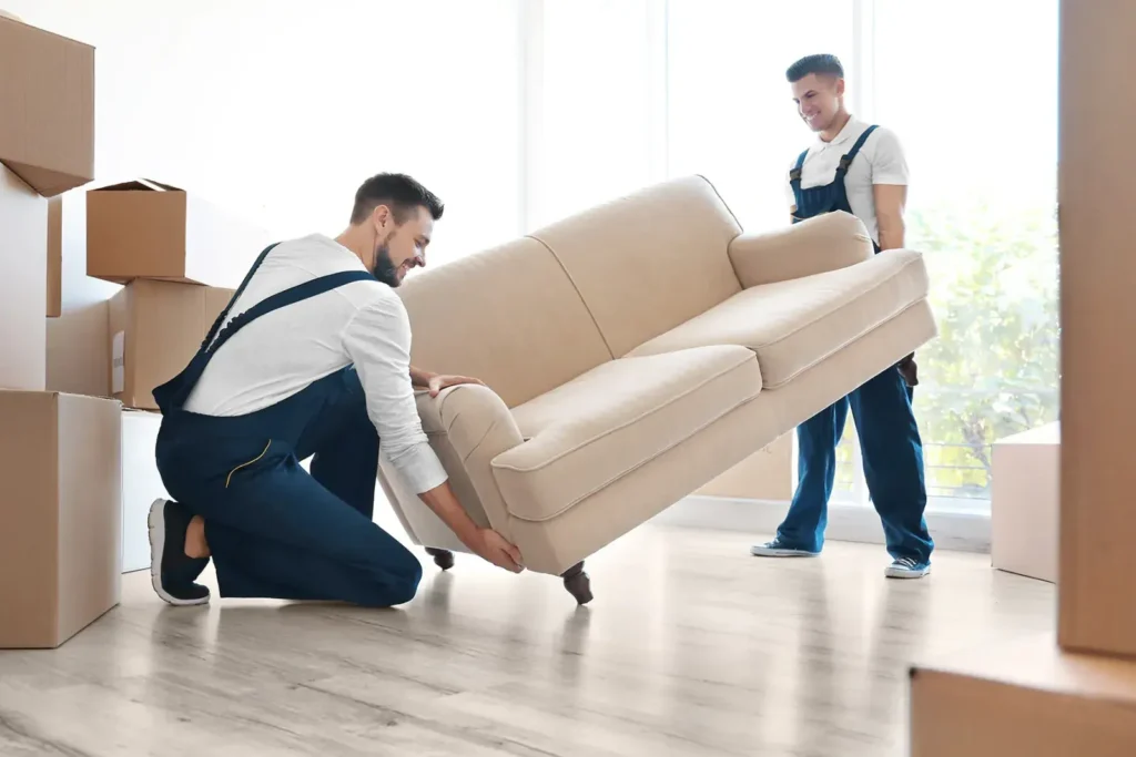 Furniture movers in Dubai - a sofa being carried and wrapped with care